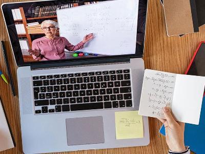 Student's desk with laptop and math notes.